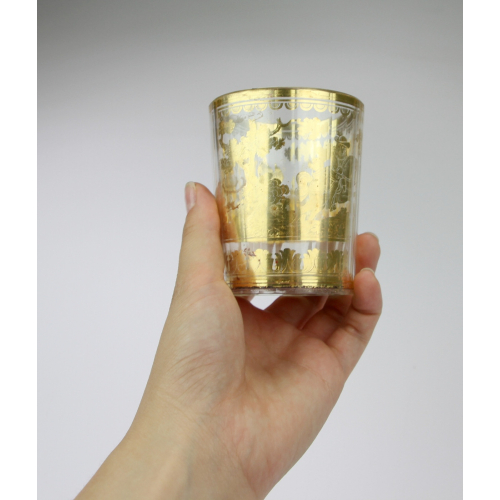 Double walled glass with a gold foil