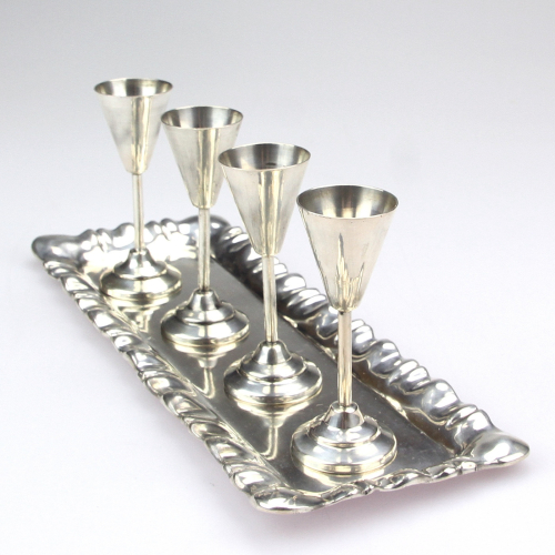 Silver liqueur cups on the...