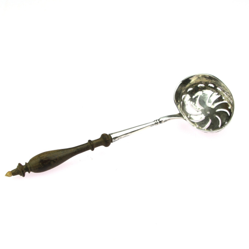 Silver tea strainer with a...