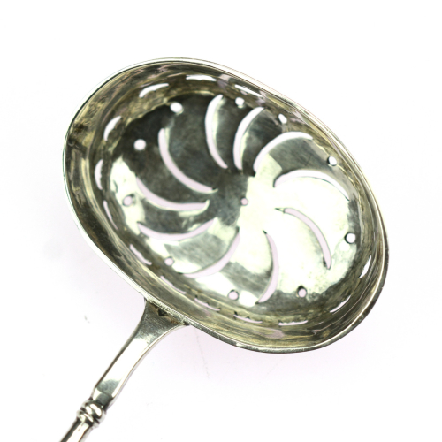 Silver tea strainer with a wooden handle