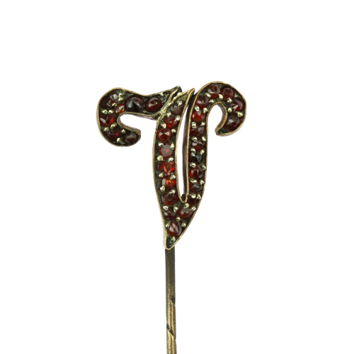 Garnet pin with letter "V"