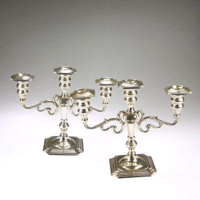 A pair of three-branched silver candelabra