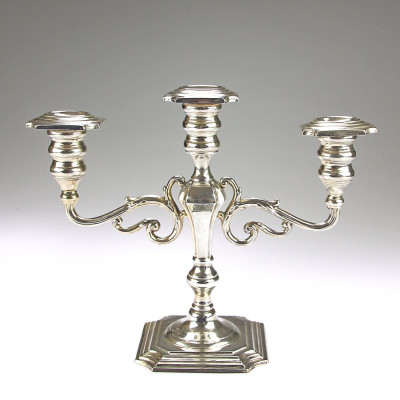 A pair of three-branched silver candelabra