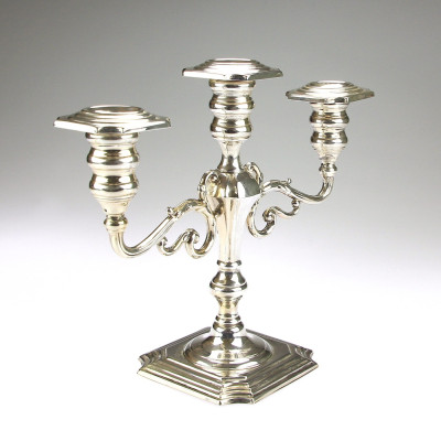 A pair of three-branched silver candelabra
