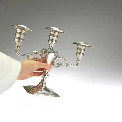 A pair of three-branched silver candelabra