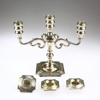 A pair of three-branched silver candelabra