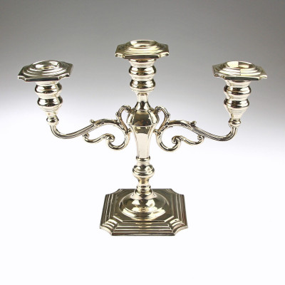 A pair of three-branched silver candelabra