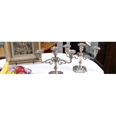 A pair of three-branched silver candelabra