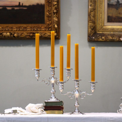 A pair of three-branched silver candelabra