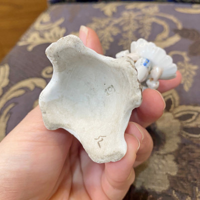 Porcelain figurine - man with vessel