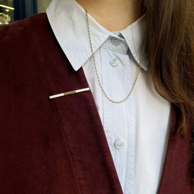 Gold bar brooch with enamel and seed pearls